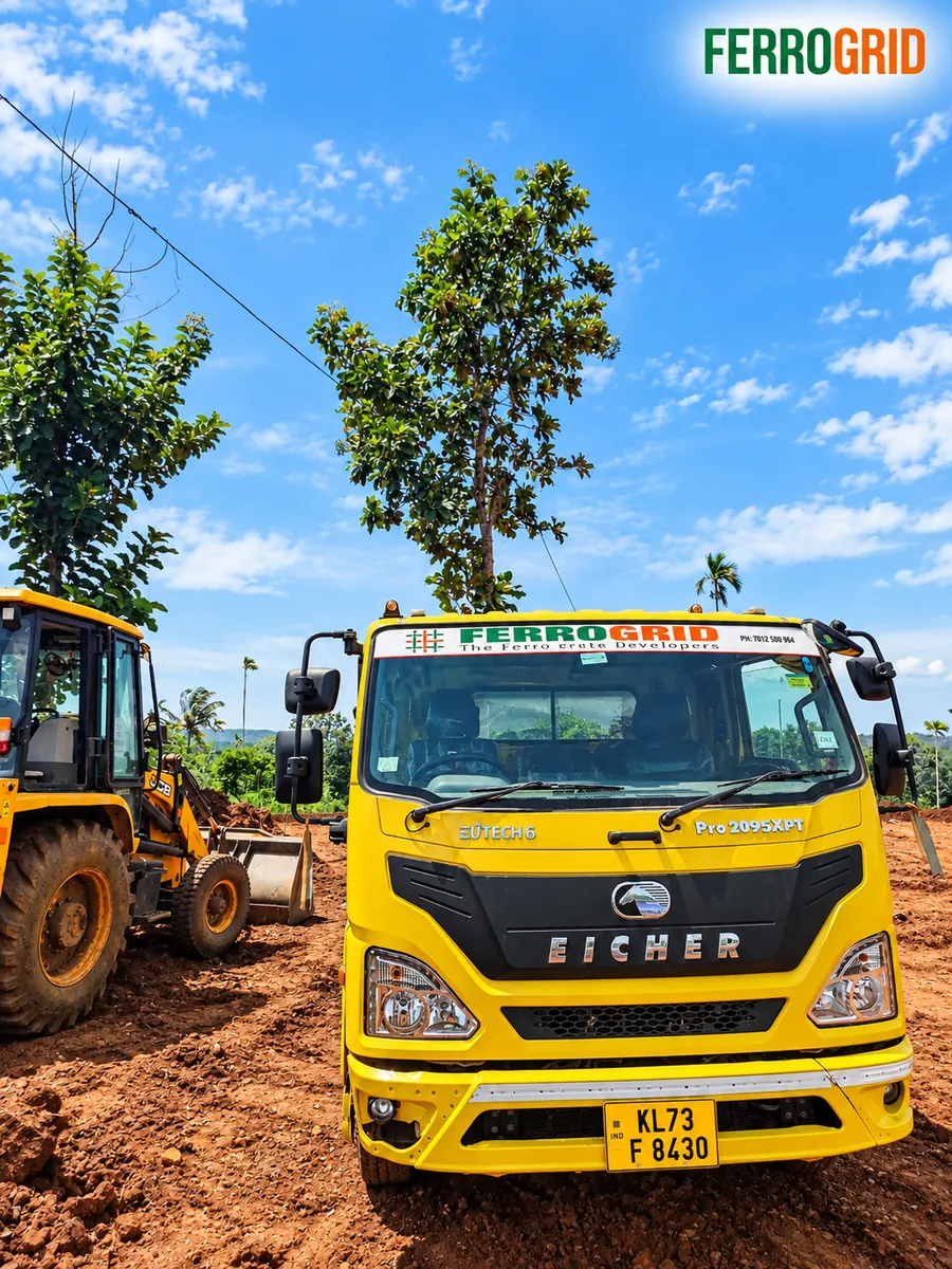 FERROGRID-branded Eicher truck with a backhoe on site
